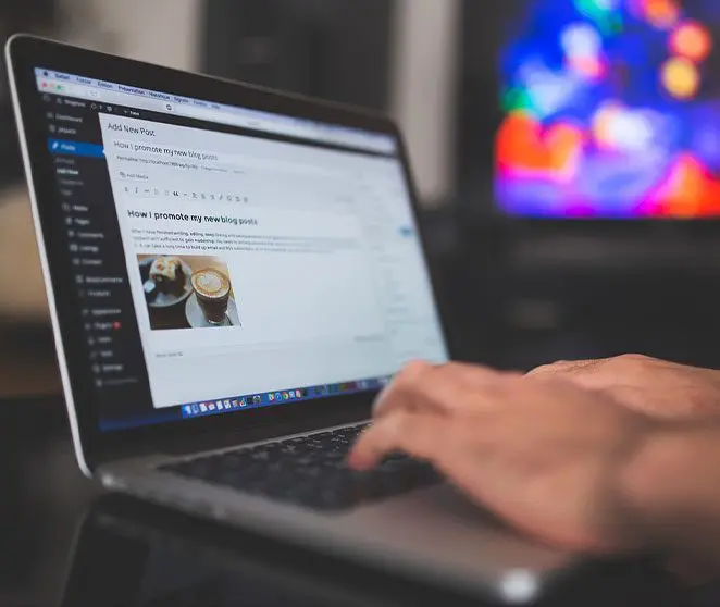 A person using their laptop on the table